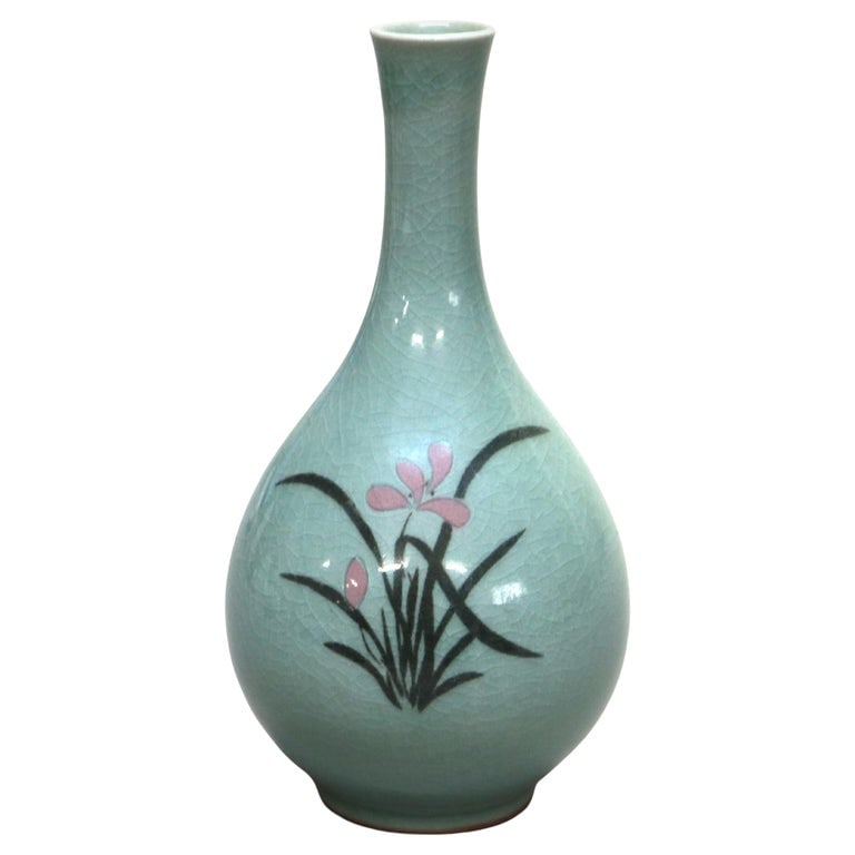 Antique Asian Celadon Pottery Bud Vase with Lily Signed 20thC: A beautifully crafted antique Asian celadon pottery bud vase from the early 19th century. This vase features a delicate lily motif, hand-painted in soft pink and black against the classic pale green c