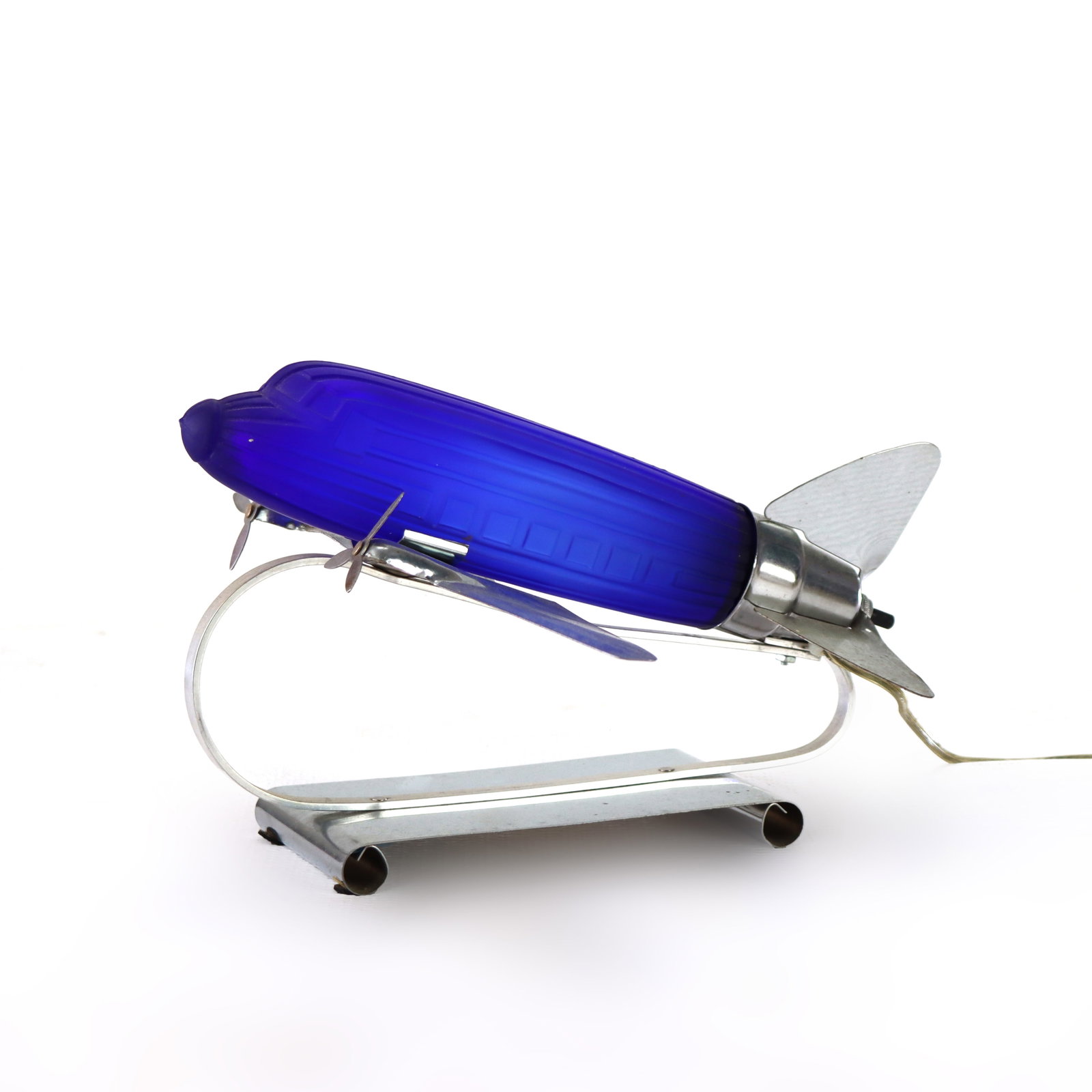 Vintage Chrome & Cobalt Blue Art Deco DC-3 Airplane Table Lamp C1977: Measures - 7 1/2" x 12 3/4" x 12 1/4". A vintage Art Deco lamp designed in the shape of a DC-3 airplane, featuring a cobalt blue glass body and chrome accents. *** OPTIONAL IN-HOUSE SHIPPING & DELIVER