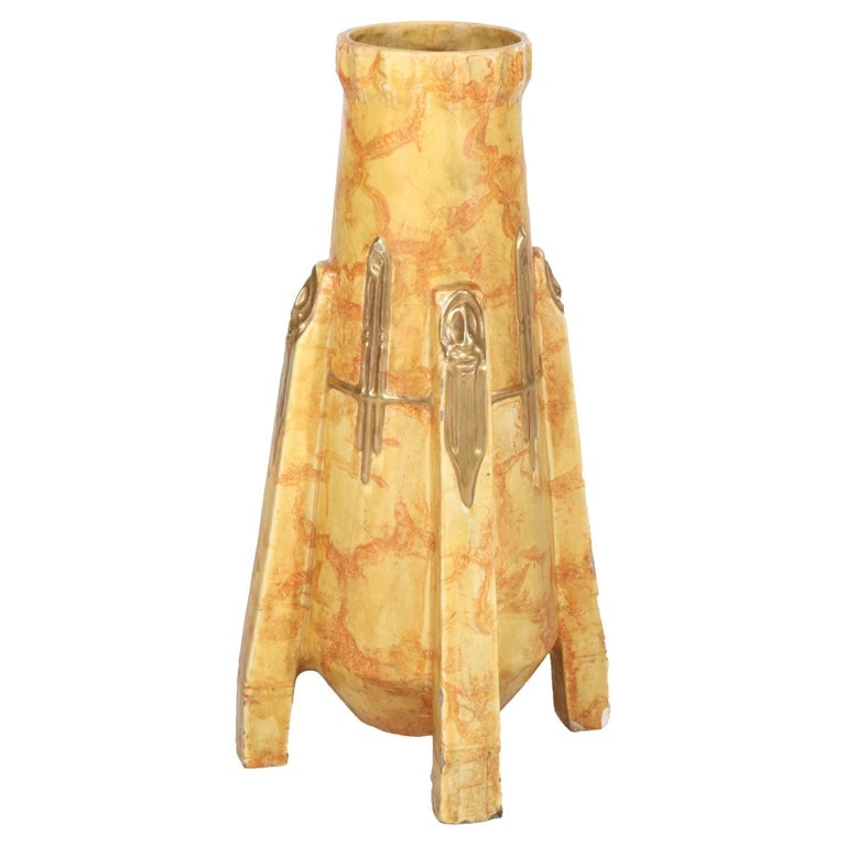Large 22" Teplitz Amphora Partial Gilt Pottery Floor Vase C1910: This Arts and Crafts floor vase, attributed to the Teplitz Amphora pottery, dates back to circa 1910. The vase features a unique design with a marbled yellow and orange glaze, complemented by applied 