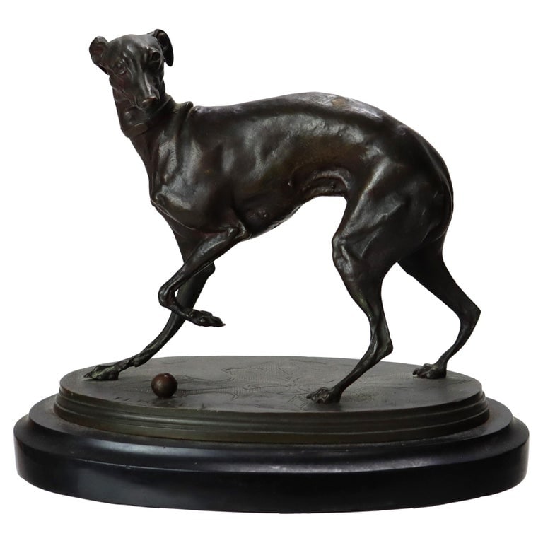 Pierre-Jules Mène 7" Bronze Sculpture Of A Whippet On A Slate Base C1890: An antique bronze sculpture by French animalier artist Pierre-Jules Mène, dating to circa 1890. Mène's masterful technique in lost-wax casting is evident in the finely detailed musculature and expre