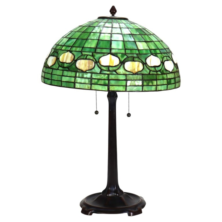 Vintage Tiffany Style Leaded Stained Glass Table Lamp With Acorn Shade 20thC: A vintage Tiffany style leaded stained glass table lamp, featuring a bronze-toned metal base and a vibrant green domed shade. This lamp, characteristic of early 20th-century design, embodies the Art N