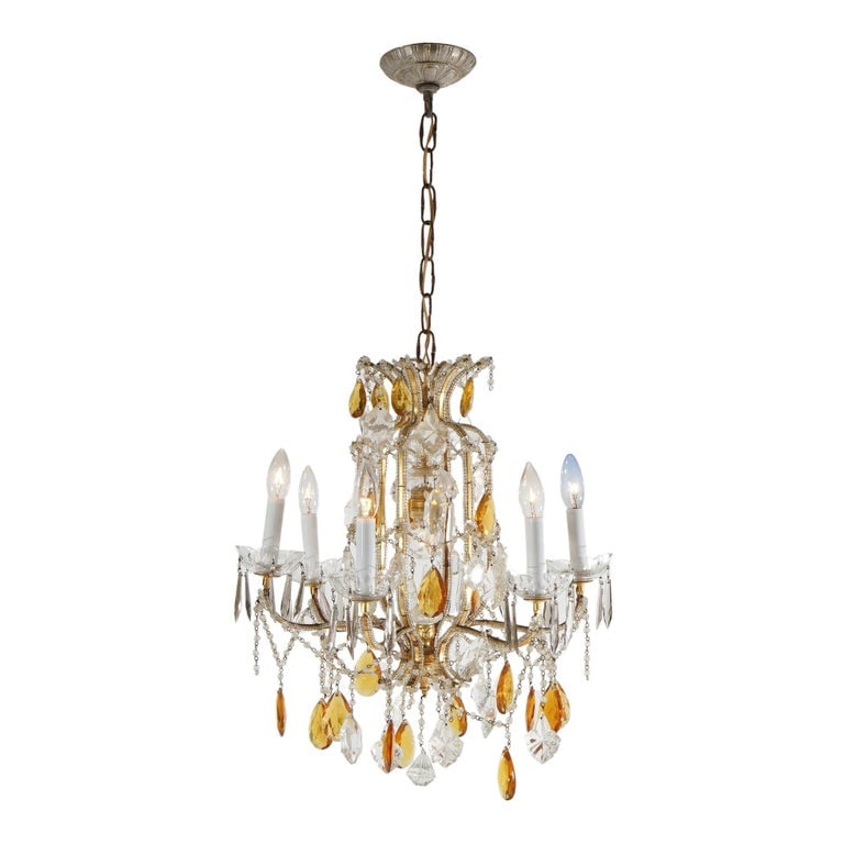 French Louis XIV Style 7-Light Crystal Chandelier with Amber Prisms, 20thC: Measures - 37"h x 18"diam. A French Louis XIV style chandelier from the 20th century, featuring seven lights and adorned with amber crystal prisms. The chandelier showcases fine metalwork and crystal 