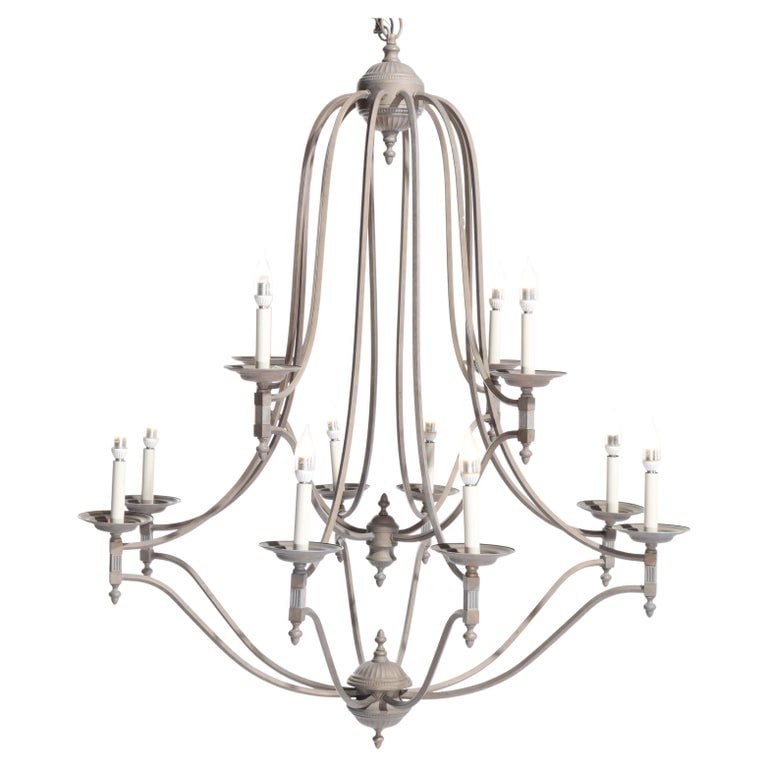 Oversized 12-Light Iron Chandelier, 20thC: An elegant oversized iron chandelier featuring 12 candle lights, each designed to hold a candle-style light bulb. The chandelier showcases a classic design with a symmetrical arrangement of arms. The 
