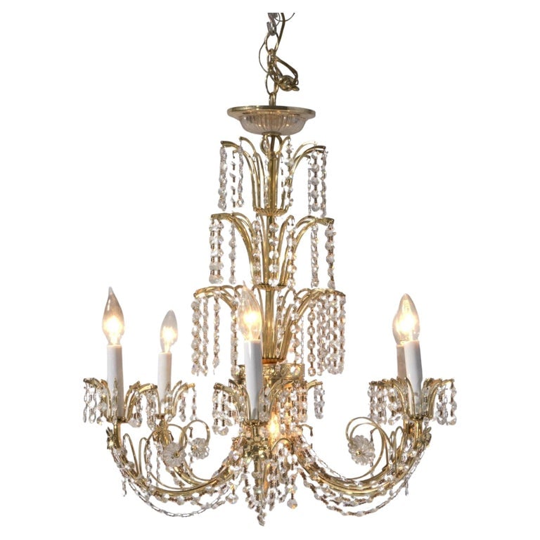 French Style Brass & Crystal Tiered Prism Chandelier 20thC: A stunning French style chandelier from the 20th century, featuring a tiered design with brass framework and cascading crystal prisms. The chandelier is adorned with multiple arms with candle-style li