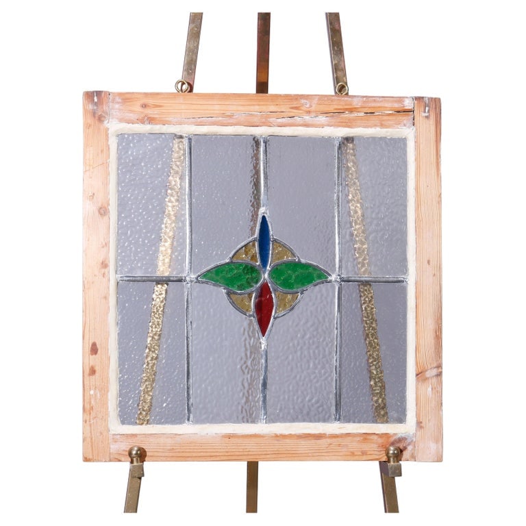 Arts & Crafts Stylized Floral Leaded Stained Glass Window, C1920: An antique Arts and Crafts leaded stained glass window panel offers central stylized floral and foliate element, seated in wood frame, c1920. Measures - 20.5''H x 20.25''W x 1.5''D. *** OPTIONAL IN-HO