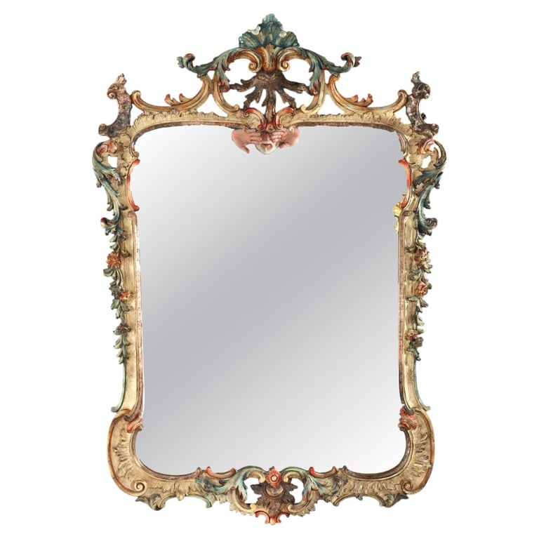 Large 54" Niccolini Italia Louis XIV Style Polychromed Mirror 20thC: A striking Italian Louis XIV style polychromed and carved mirror, signed Niccolini and dating to the 20th Century. This substantial wall mirror features an elaborately sculpted wooden frame, character