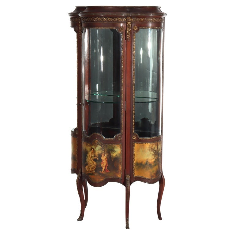 French Mahogany & Ormolu Vitrine With Vernis Martin Panels C1890: Measures - 57 1/2" x 27 1/8" x 16 1/2". This antique French vitrine, dating to circa 1890, is crafted from mahogany and adorned with intricate ormolu mounts. The piece features Vernis Martin panels, s