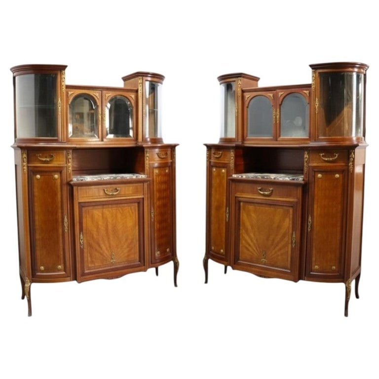 Pair Mahogany, Parquetry & Ormolu Credenzas With Beveled Glass Upper C1890: A distinguished pair of antique mahogany credenzas, circa 1890, featuring exquisite parquetry detailing and ornate ormolu mounts. Each credenza is designed with a central lower cabinet adorned with ra
