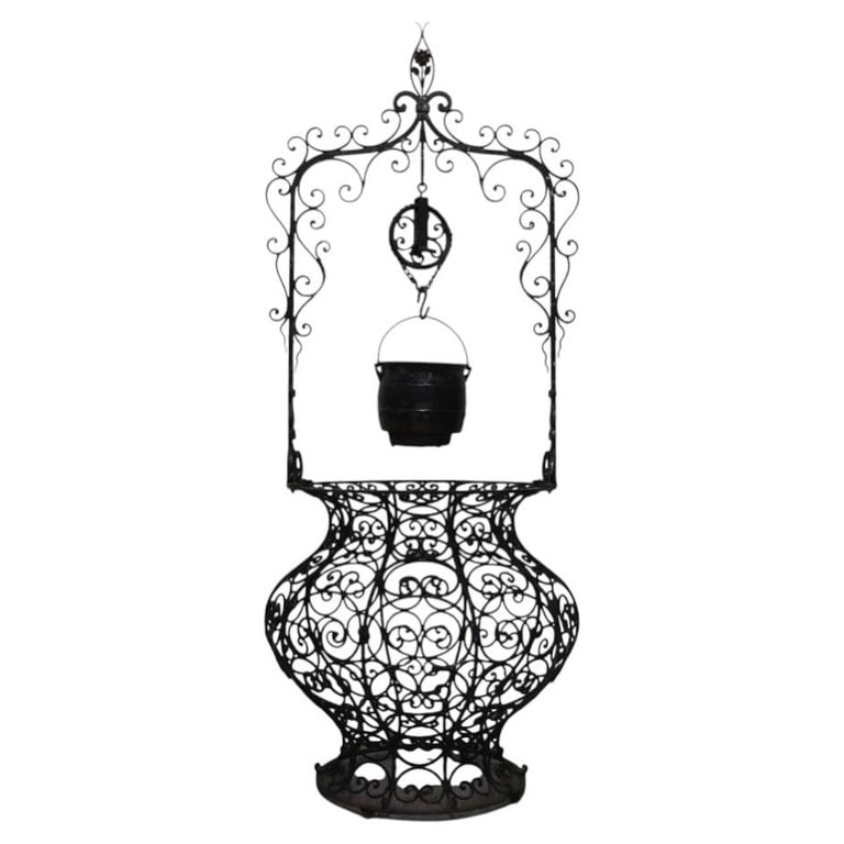 Monumental 99" Black Painted Metal Wishing Well With Cast Iron Planter C1920: An antique metal wishing well with an integrated cast iron planter, dating to approximately 1920. This substantial garden ornament features intricate scrollwork and filigree designs characteristic of 