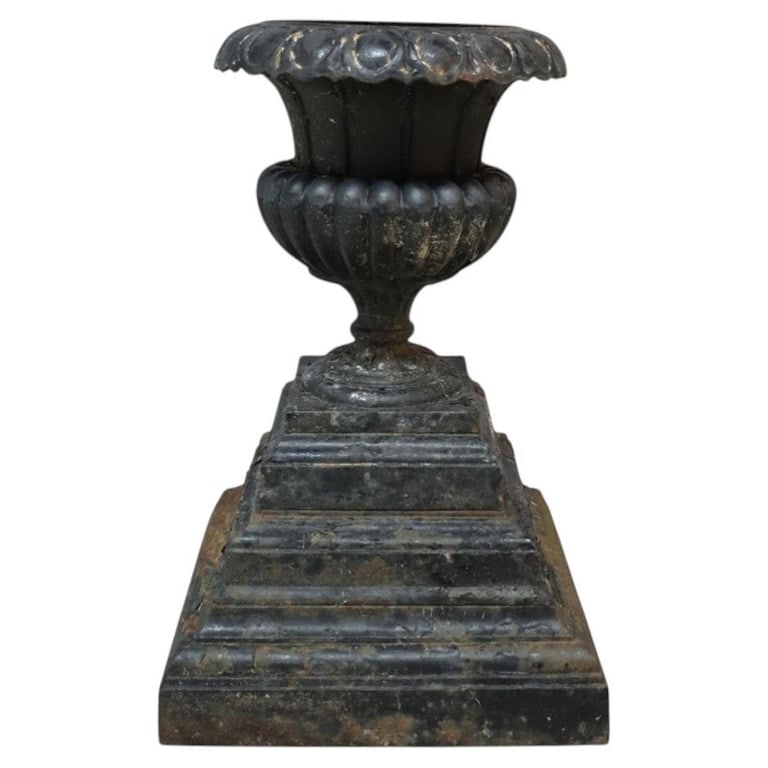 Fiske Form Cast Iron Garden Urn C1890: An antique cast iron garden urn, produced in the manner of the renowned Fiske, dates to circa 1890. Crafted from durable cast iron, the urn presents a timeless Neoclassical silhouette, characterized b
