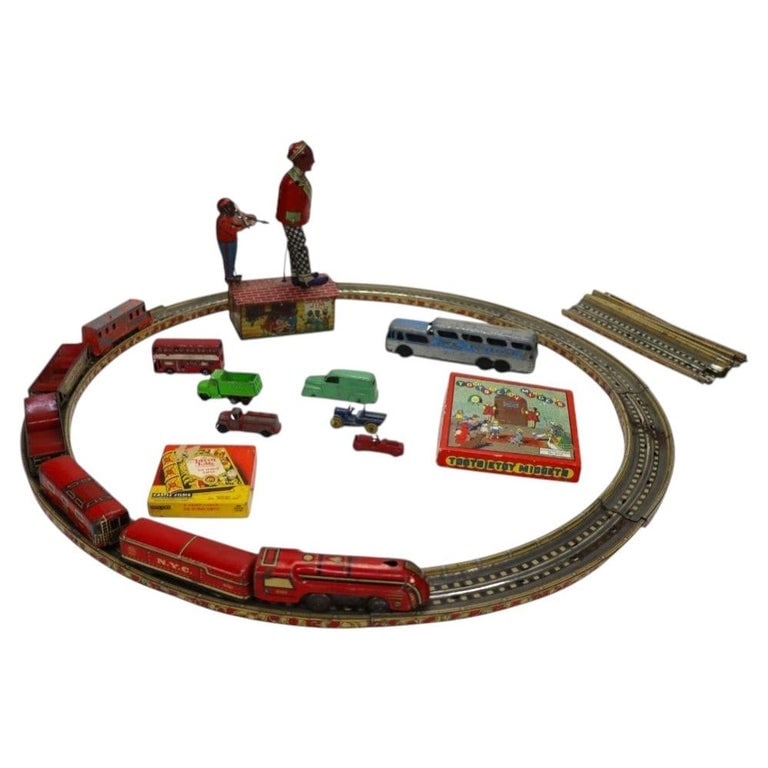 Various Children’s Antique Toys: Tootsietoy Midgets, Dancer On Roof, Toy Train: Various Children’s Antique Toys: Tootsietoy Midgets, Fairy Fable Film Cartoon, Dancer On The Roof, Toy Train & Track Set. Measures - 9.5"H x 5"W x 3.5"D(Largest). *** OPTIONAL IN-HOUSE SHIPPING & DE