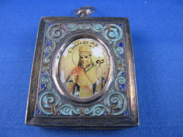 HAND PAINTED RUSSIAN ICON WITHIN A SILVER FRAME WIT: 19TH C HAND PAINTED RUSSIAN ICON WITHIN A SILVER FRAME WITH TOUCHMARKS AS ILLUSTRATED. LIGHT AND DARK BLUE ENAMELLED FRONT WITH OVAL IMAGE. SOME PAINT LOSS TO THE IMAGE, 2" X 1 1/2"