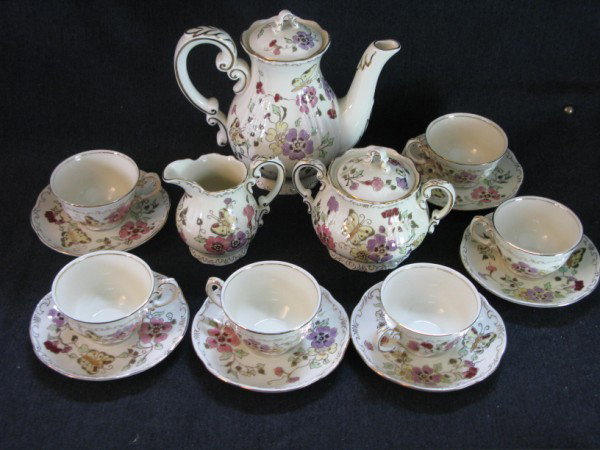 ZSOLNAY MOCHA /COFFEE SET: BUTTERFLY DECOR HANDPAINTED IN HUNGARY, FIFTEEN PIECES INCLUDING COFFEE POT, CREAM AND SUGAR, SIX CUPS AND SIX SAUCERS. IN EXCELLENT CONDITION