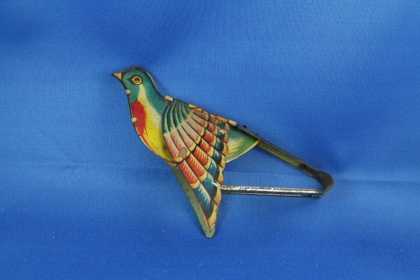 ANTIQUE GERMAN BELLOWS OPERATED BIRD TIN TOY: ALL ORIGINAL, ONE WING JUTS OUT MORE THAN THE OTHER, GOOD COLOUR, NOT CLEANED. AS FOUND 7" L X 3.5" H