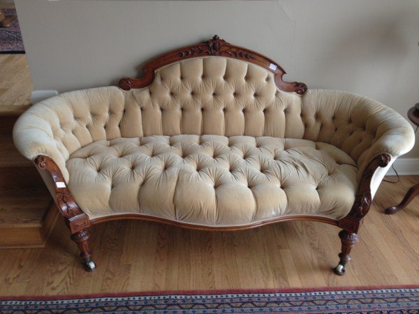 ENGLISH VICTORIAN BUTTON BACK SETTEE: WITH PORCELAIN CASTERS