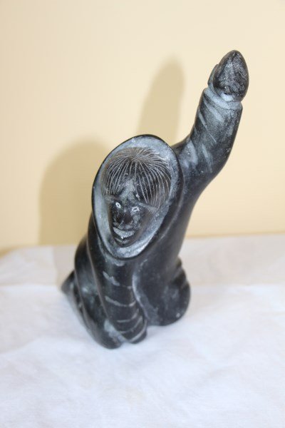 INUIT STONE CARVING: KNEELING HUNTER SIGNED BY JACOB IRKOK IN SYLLABICS SPEAR MISSING 9.5" H