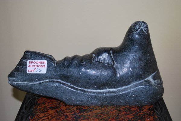 INUIT STONE CARVING: RECUMBENT SEAL SIGNED IN SYLLABICS WITH COOPERATIVE SEAL ON BASE 5" H X 11.5" L