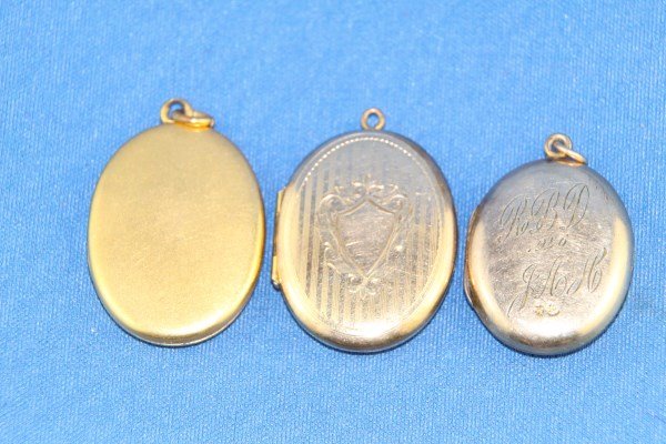 THREE EDWARDIAN OVAL LOCKETS: ONE ENGRAVED AND DATED 1926