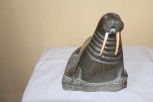 INUIT STONE CARVING OF A WALRUS: SIGNED IN SYLLABICS MINOR CHIP TO BASE 7.25" L X 6.5" H