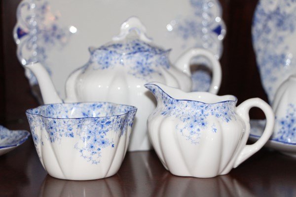 SHELLEY DAINTY BLUE LUNCHEON SERVICE FOR EIGHT: EIGHT LUNCHEON PLATES, EIGHT BREAD PLATES, EIGHT CAKE PLATES, EIGHT CUPS AND SAUCERS, EIGHT FRUIT BOWLS, TEAPOT, CREAM AND SUGAR, SQUARE DESSERT PLATE AND COVERED BUTTER DISH