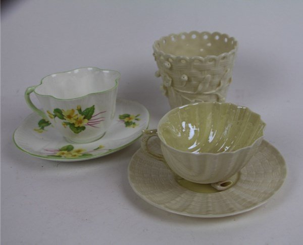 LOT OF BELLEEK AND SHELLEY: SHELLEY "PRIMROSE' CUP AND SAUCER" BELLEEK SHELL FORM CUP AND SAUCER BELLEEK BASKET WEAVE VASE WITH FLORAL SPRIG DECORATION