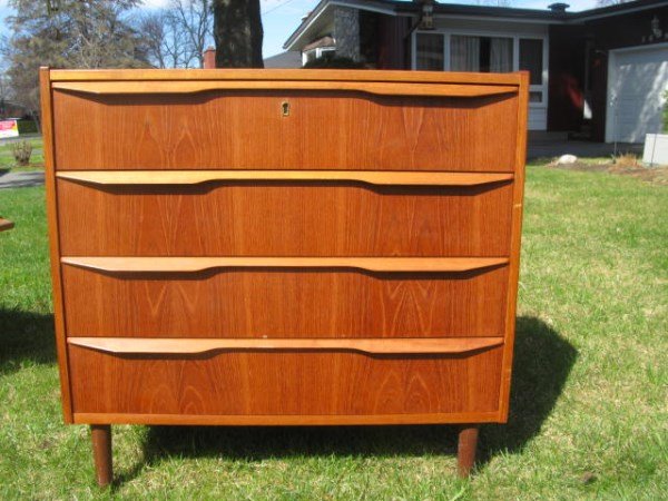 FOUR DRAWER TEAK CHEST: RAISED ON TURNED LEGS IN GOOD CONDITION 30" H X 31" W X 16" D