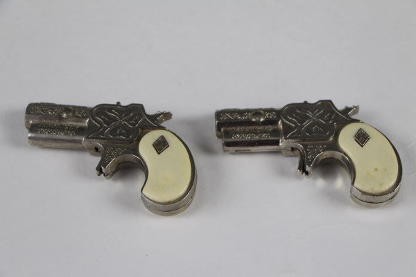 PAIR OF MINIATURE TOY DILLINGER CAP GUNS (1 of 2)