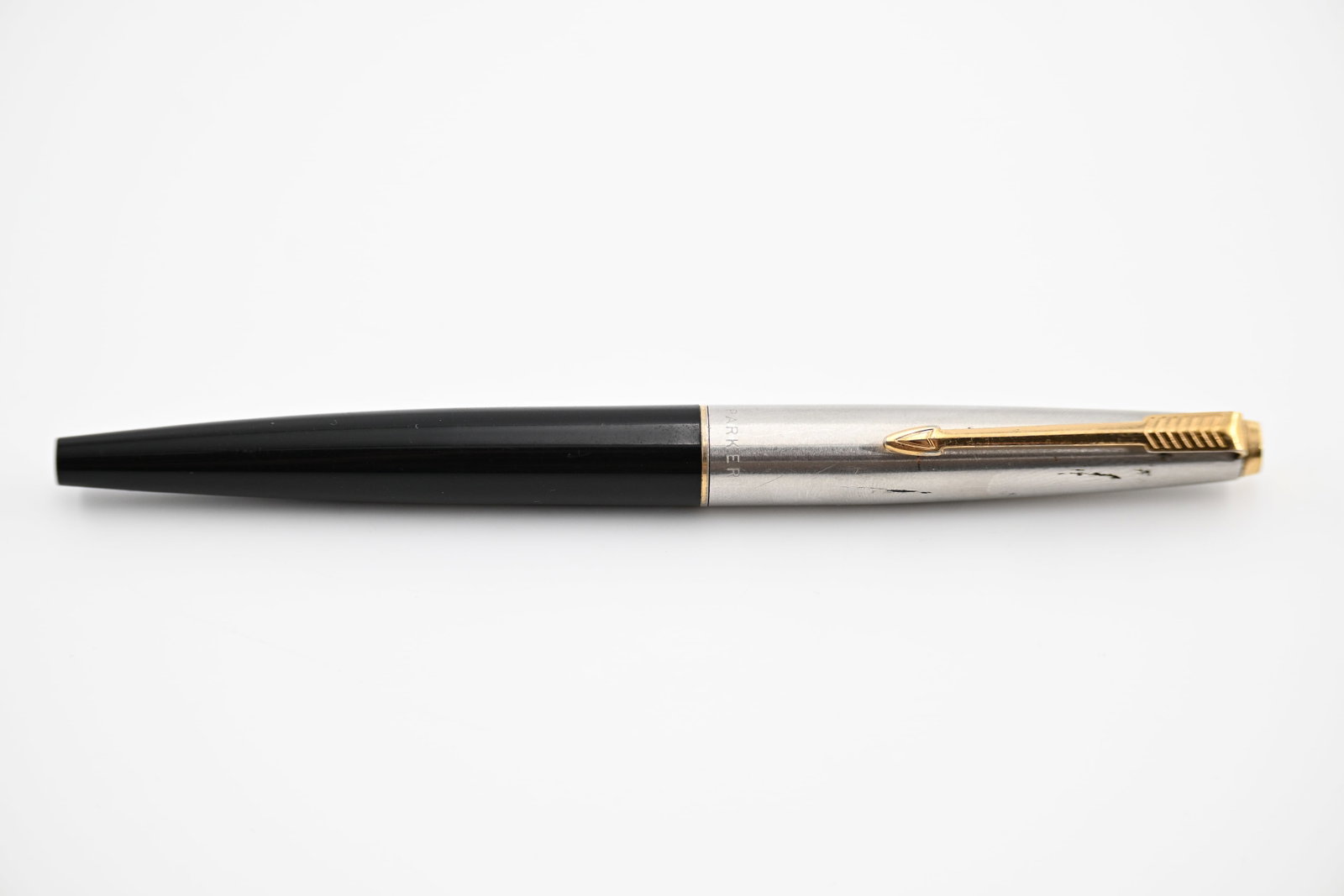 Vintage Parker 45 Fountain Pen with Stainless Steel Cap and Black Barrel: Classic Parker 45 fountain pen featuring a brushed stainless steel cap with signature gold-tone Parker arrow clip paired with a glossy black barrel. Key Features: Parker (UK or USA) cartridge-converte
