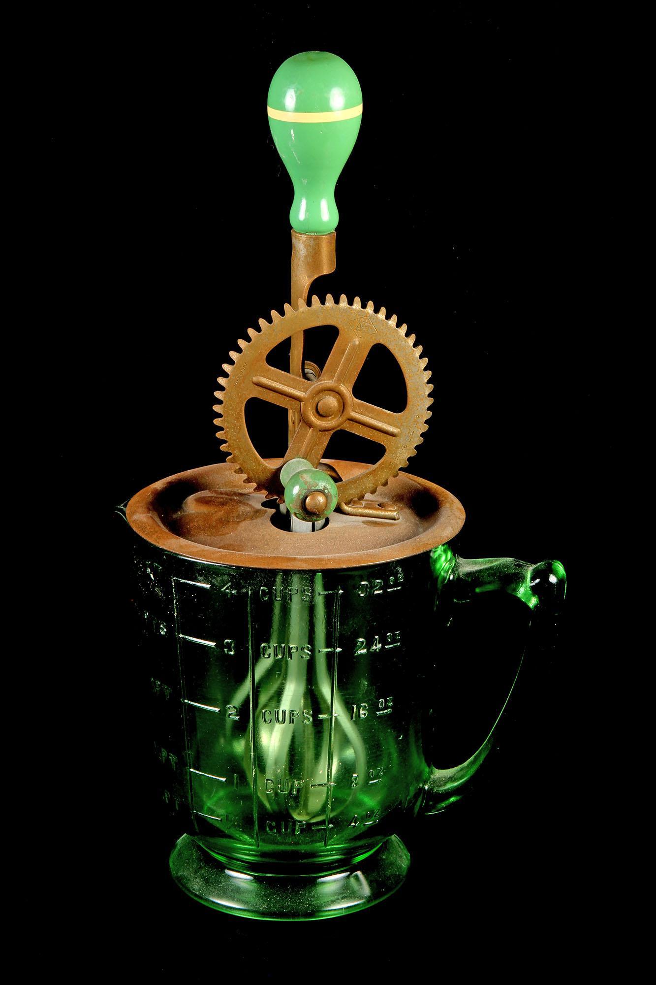 Vintage Depression Glass Green Hand Mixer: Vintage Depression Glass Green Hand Mixer 13" H Condition- Consistent with age wear We are not glass experts and have tried to identify the pieces to the best of our ability. Please review all photos