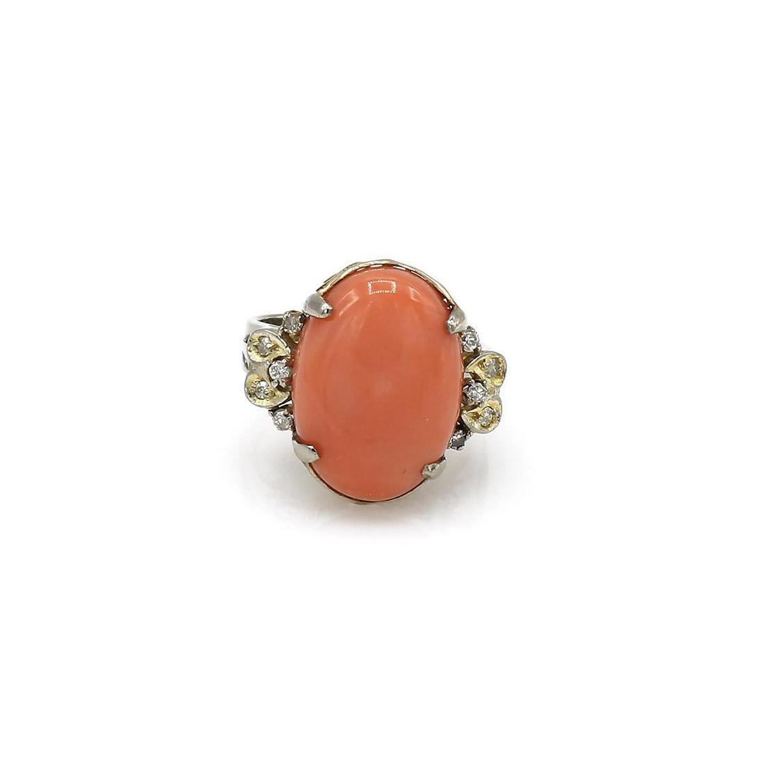 18K Yellow Gold Coral Cabochon and Diamond Ring: 18k yellow gold ring featuring an oval salmon colored coral cabochon along with 10 accent diamonds running down the sides with I1-I2 clarity. It is 19mm wide at the top, a size 5.5, and it weighs 8 gr