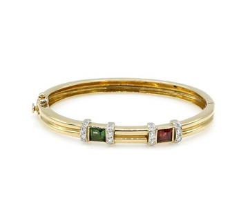 14K Yellow Gold Diamond Tourmaline & Garnet Bangle: Bangle bracelet in 14k yellow gold featuring approx 0.32ctw of diamonds, a princess cut green tourmaline, and a princess cut garnet. It has an approx 6.25 inner circumference, 8mm wide, and weighs