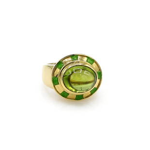 18K Yellow Gold Peridot Cabochon Cockail Ring: Cocktail ring in 18k yellow gold featuring a vibrant peridot cabochon weighing approx 6.00cts accented with bright green enamel. It is 16mm wide at the top, a size 5.5, and it weighs 16.6 grams. 