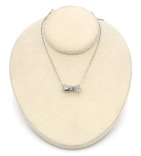 Mimi So 18K WG Pave Diamond Bowtie Pendant Necklace: Necklace in 18k white gold by Mimi So featuring 0.61ctw of round brilliant cut diamonds set into a bowtie pendant. 15-16" adjustable chain, pendant measures 17mm x 7mm. Necklace weighs 4.6 grams.