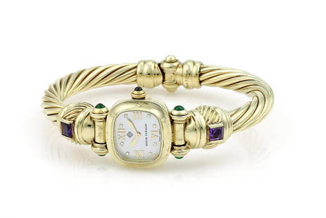 David Yurman Tourmaline and Amethyst Cable Watch in YG: David Yurman cable watch in 14k yellow gold featuring a diamond white mother of pearl dial along with green tourmaline and amethyst gemstones. Runs on an accurate quartz movement. 7mm cable, 21mm