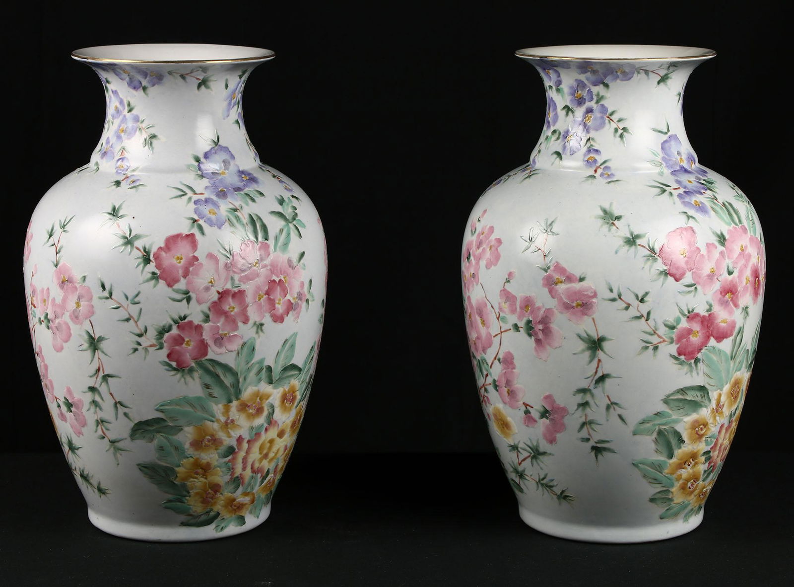 Pair of Chinese Porcelain Floral Urns: Pair of Chinese painted urns featuring a purple, pink, and yellow floral motif. They measure approx 13" tall. Shows minor loss to gold foil on rim. Have a similar item to sell? Contact us at info&