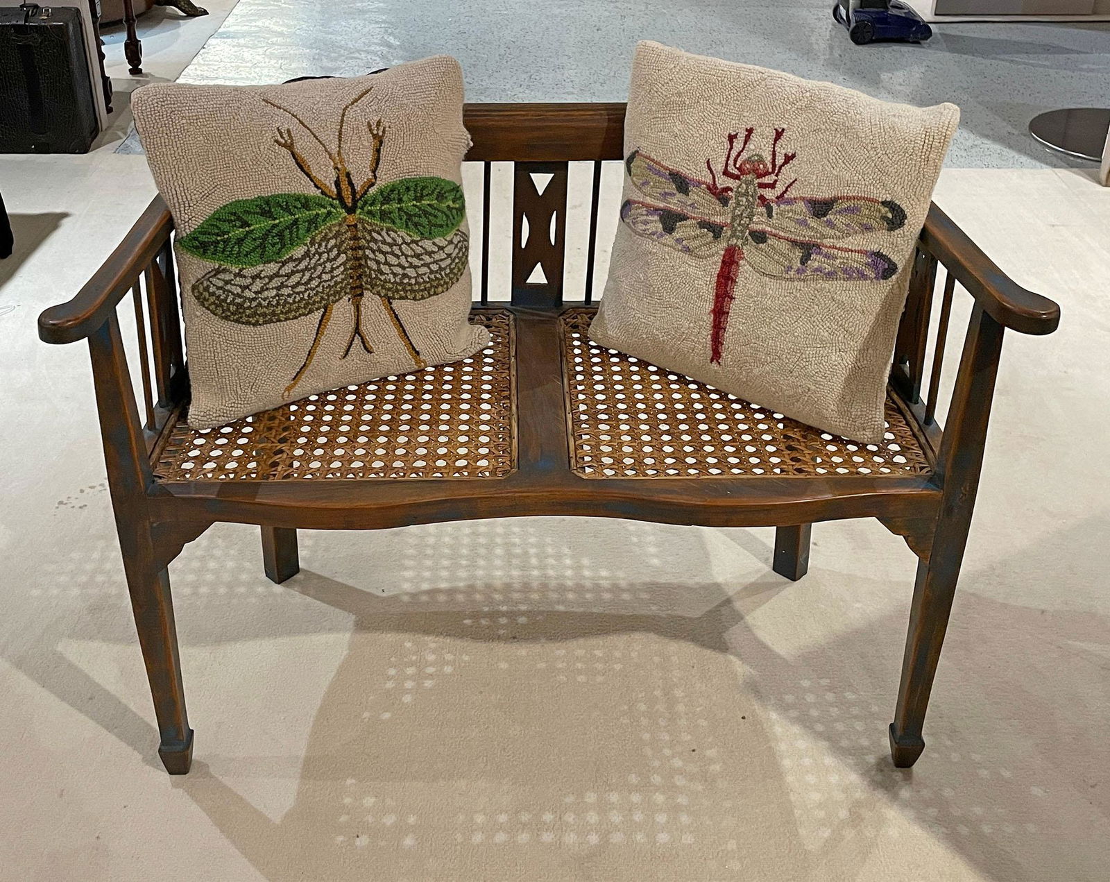 Carved Wood Caned Bench: Medium stain with carved bench with cane base with pillows. Measures approx 30" h x 41" w x 20.5" d. Seat height 18". Have a similar item to sell? Contact us at info@marketauctions