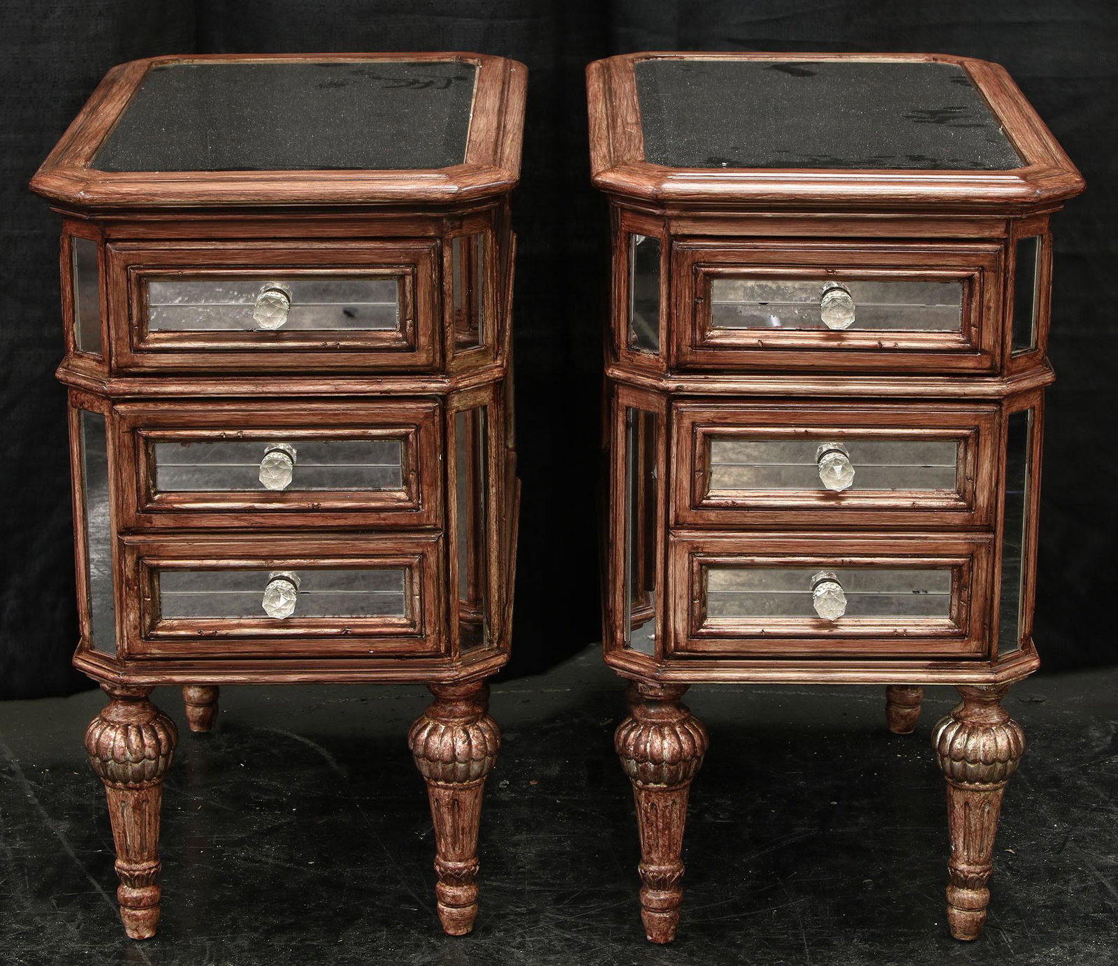 Pair of Mirrored Side Tables: A pair of mirrored side tables featuring a antiqued wood finish with mirrored glass panels throughout. We believe these to be the Dresden side tables originally offered through Neiman Marcus. One of t