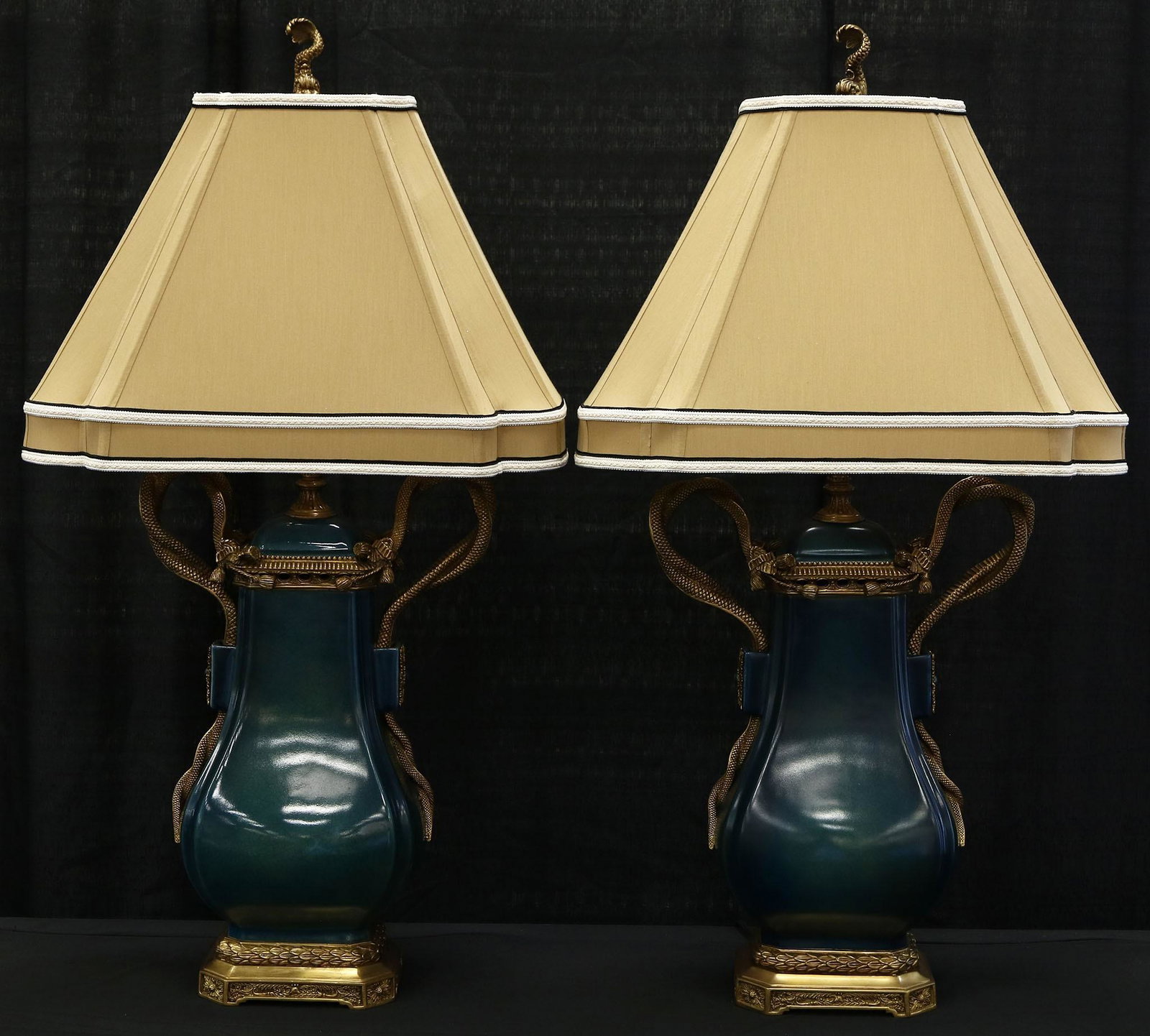 Pair of Wildwood Table Lamps: Pair of table lamps by Wildwood Lamps and Accessories. They measure approx 37” tall (base to finial) x 20.25” w at the shade. The insides of the shades do show a mark here or there. Lamp f