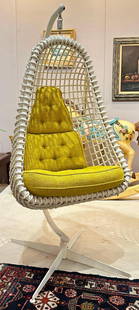 Hanging Cocoon Chair: Mid century modern hanging rattan cocoon chair with metal stand. It is in overall good condition just showing some blemishing to the finish. It measures approx 71" t x 32" w x 40" d. Seat height 27".
