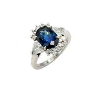 Cartier Platinum Sapphire & Diamond Ring: Beautiful Cartier ring in platinum featuring a blue sapphire surrounded by diamonds. It is 14mm wide at the top, a size 4.5, and weighs 6 grams. Shank shows wear consistent with use. wc1065401 