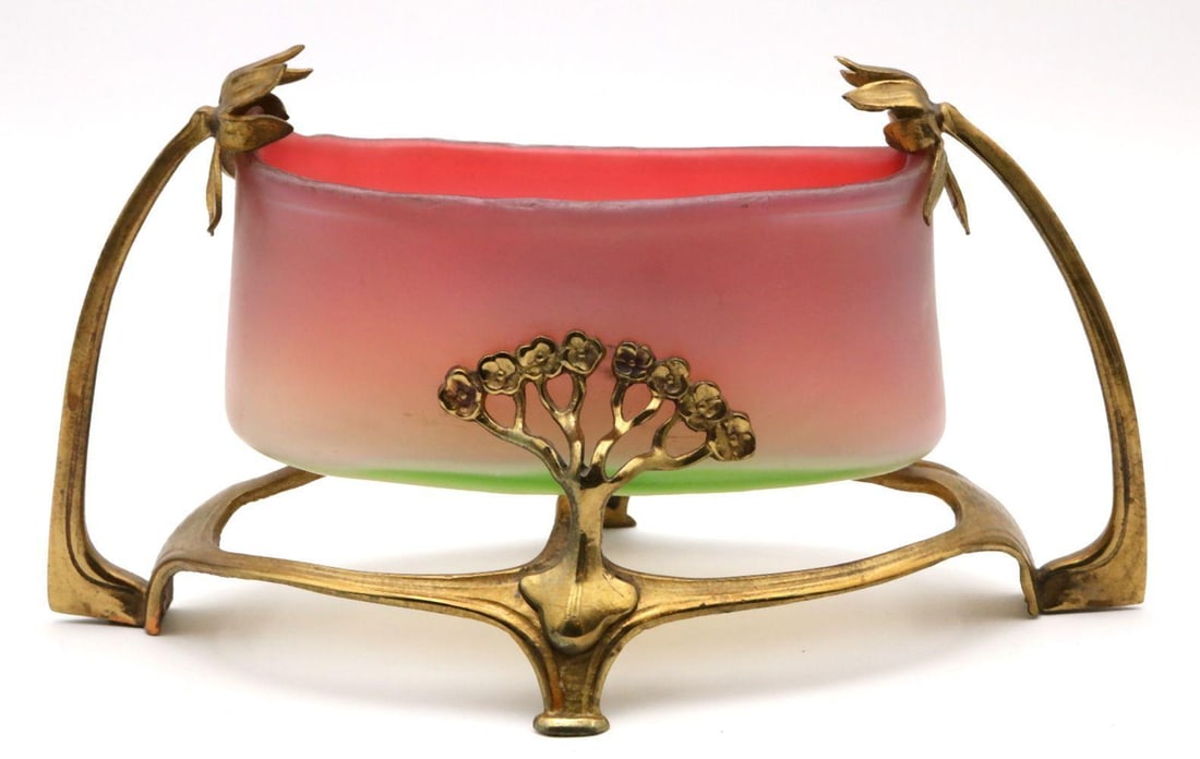 Loetz "Syrius" Iridescent Glass Footed Bowl: Loetz "Syrius" Iridescent Glass & Gilt Metal Mounted Footed Bowl. Unmarked. Measures approx. - 4 3/4" high x 9" long x 5 1/4" deep. Have a similar item to sell? Contact us at i