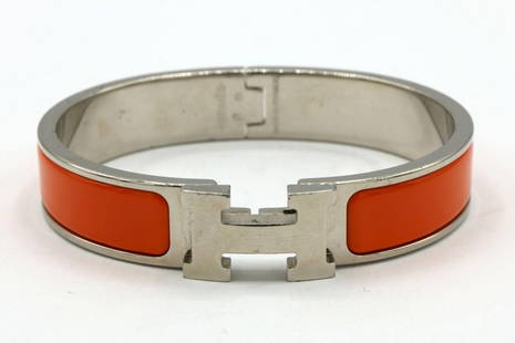 Hermes Orange Clic H Enamel Bracelet: Hermes Orange Clic H Enamel Bracelet. Measures approx. - 3/8&#34; thick. Measures approx. - 2&#34; inside across.  Have a similar item to sell? Contact us at info&#64;marketauctionsinc.com **If you do