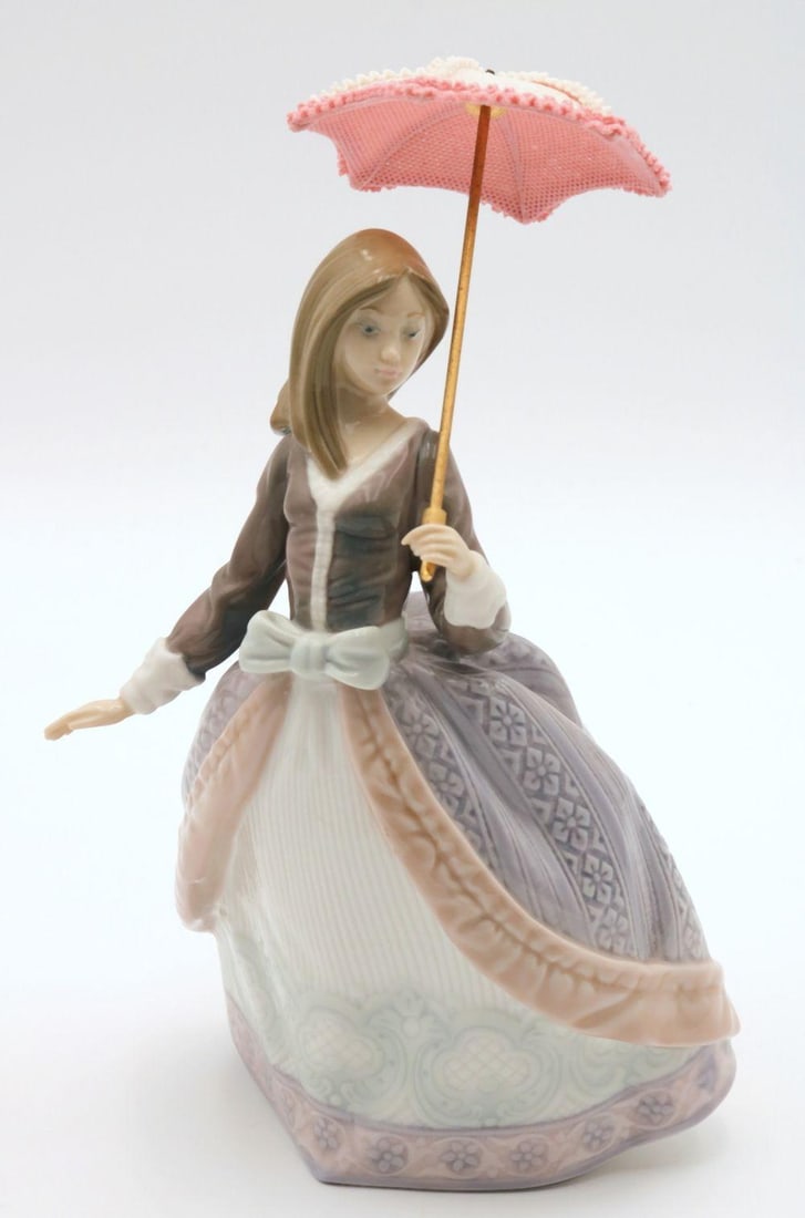 Lladro "Angela" #5211 Porcelain Sculpture: Lladro "Angela" #5211 Porcelain Sculpture. With parasol umbrella, please note - top finial is missing, being sold as is. Measures approx. - 8 1/2" high x 5 1/2" wide. Have a similar it