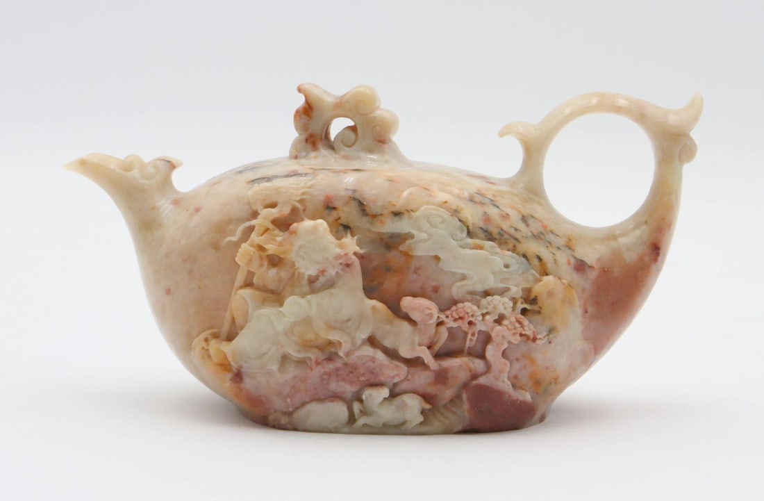 Chinese Hand Carved Jadeite Tea Pot: Chinese Hand Carved Jadeite Tea Pot. Depicting immortal scene. Measures approx. - 3 1/2" high x 7" wide. Have a similar item to sell? Contact us at info@marketauctionsinc.com Please review