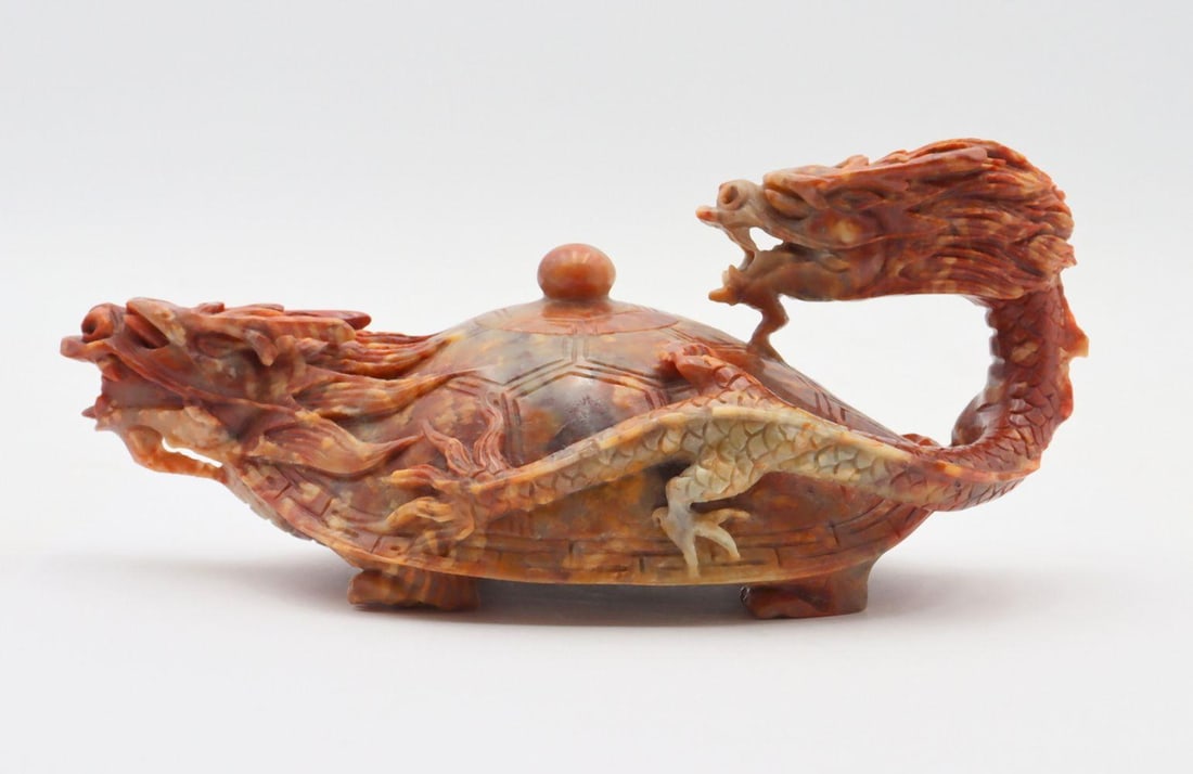Chinese Hand Carved Jadeite Tea Pot: Chinese Hand Carved Jadeite Tea Pot. Depicting dragon head at spout and handle. Measures approx. - 3" high x 8" wide. Have a similar item to sell? Contact us at info@marketauctionsinc.com