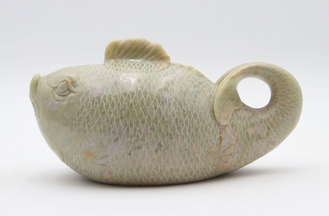 Chinese Hand Carved Jadeite Tea Pot: Chinese Hand Carved Jadeite Tea Pot. Depicting a fish. Measures approx. - 4 1/2" high x 8" wide. Have a similar item to sell? Contact us at info@marketauctionsinc.com Please review all pho