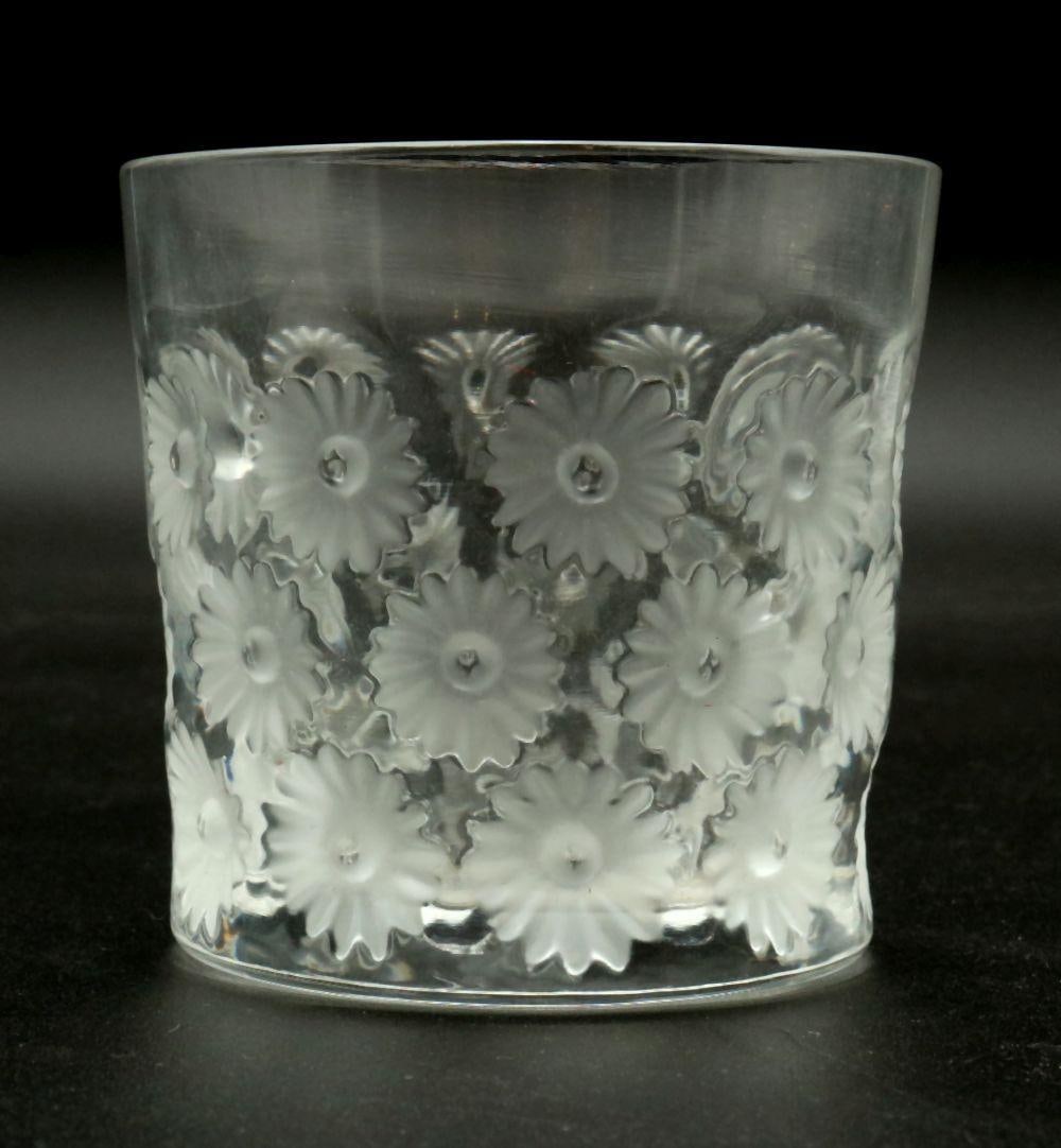 Lalique " Napsbury" Crystal Tumbler: Lalique France " Napsbury" Crystal 8oz Tumbler. Depicting daisies. Measures approx. -3" high x 3" wide. Have a similar item to sell? Contact us at info@marketauctionsinc.com Please