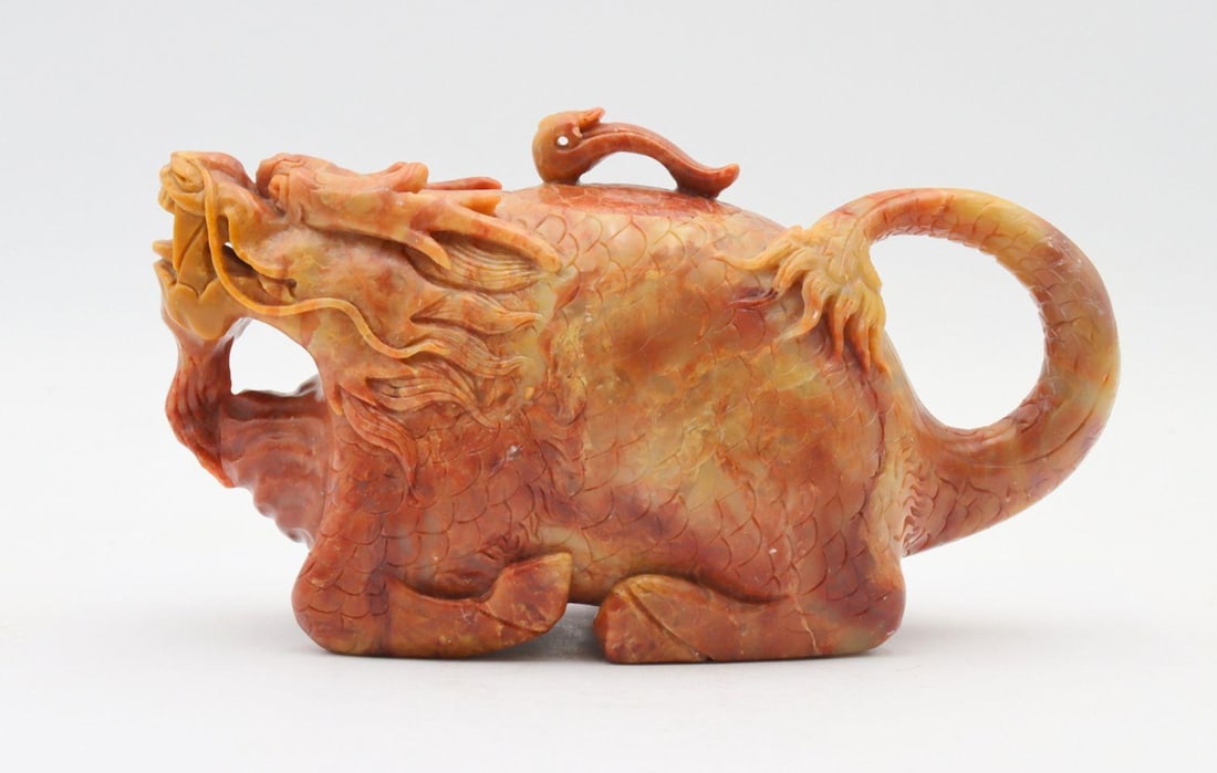 Chinese Hand Carved Jadeite Tea Pot: Chinese Hand Carved Jadeite Tea Pot. Depicting dragon head at spout. Measures approx. - 4" high x 7 1/2" wide. Have a similar item to sell? Contact us at info@marketauctionsinc.com Please