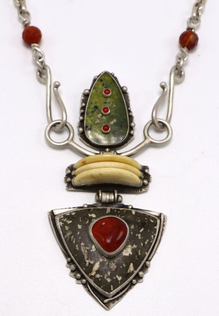 Unique Jim Dunakin Navajo Semi-Precious Stone & Sterling Pendant Necklace: Unique Jim Dunakin Navajo Semi-Precious Stone & Sterling Pendant Necklace. Contains carnelian on serpentine bone, citrus chalcedony on river rock carnelian beads. Measures approx. - 21" long. pendant