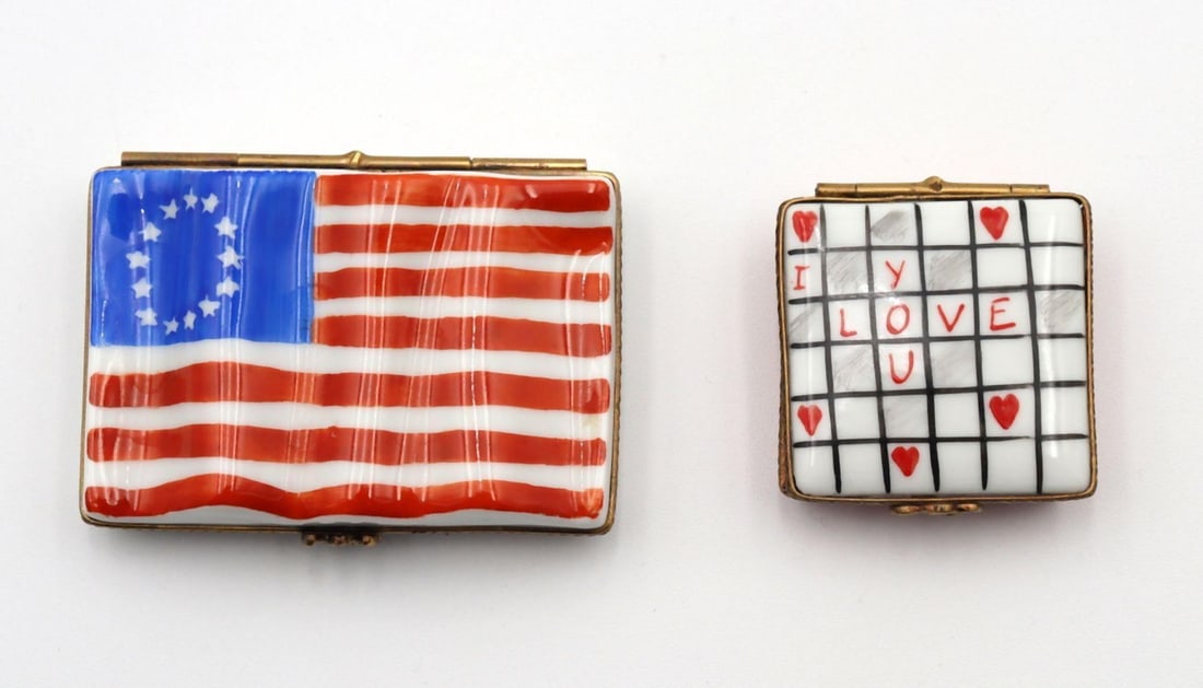Two Limoges France Porcelain Pill Boxes: Two Limoges France Porcelain Pill Boxes. I love you box measures approx. - 1 5/8" square. American Flag box measures approx. - 2 7/8" long. Have a similar item to sell? Contact us at info@
